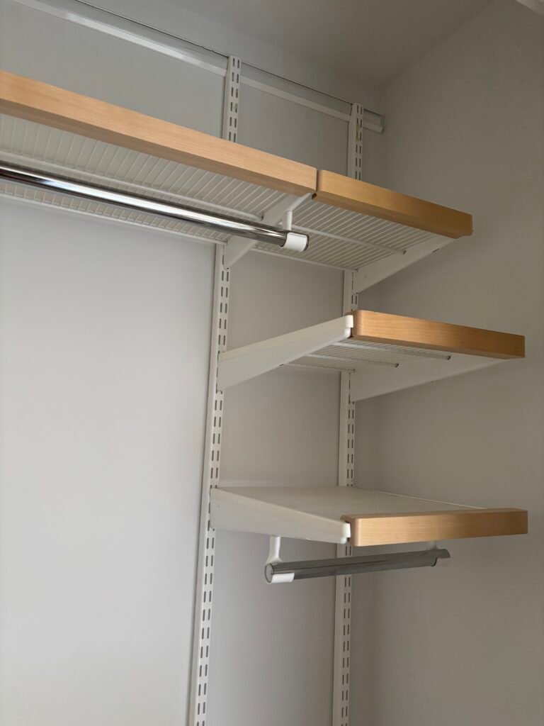 Closet shelves and hanging rod installed on wall rails, NYC