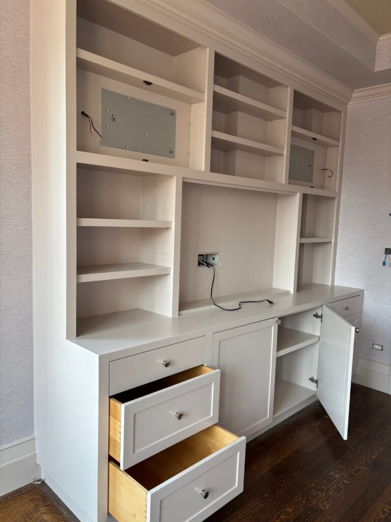 White built-in wall unit with shelves, drawers and cabinets installed, NYC