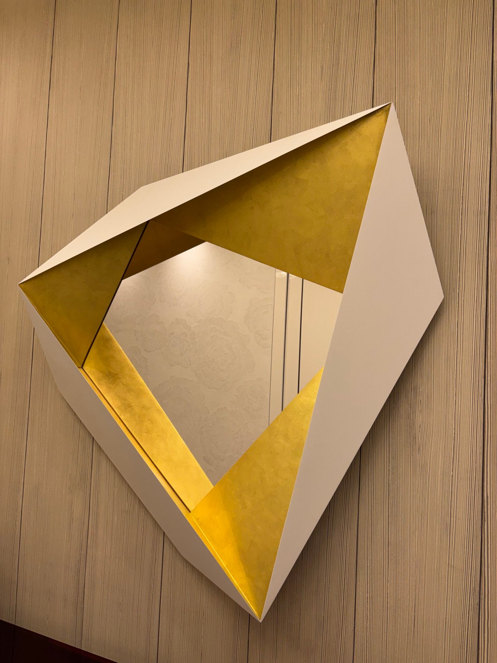 Geometric gold-leaf wall mirror mounted, NYC apartment