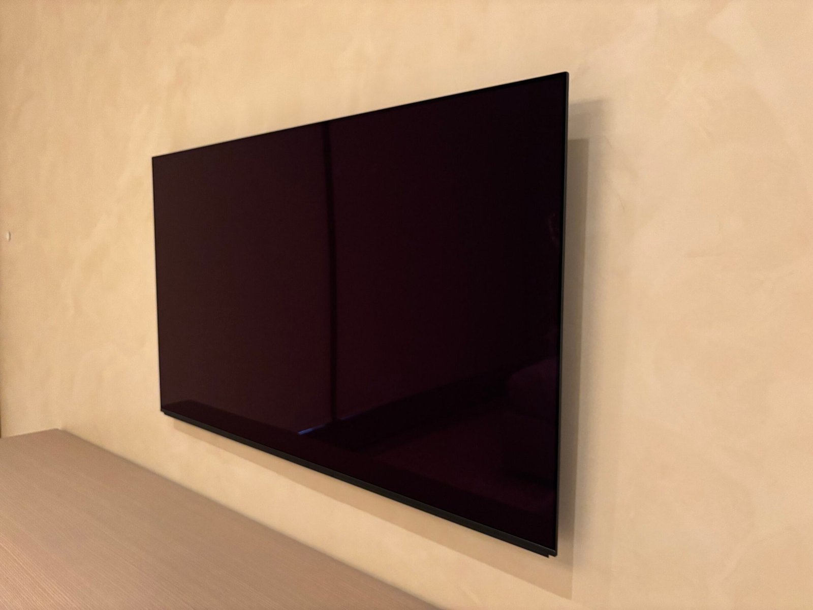 Flat screen TV wall mounted flush on a plaster wall, NYC apartment