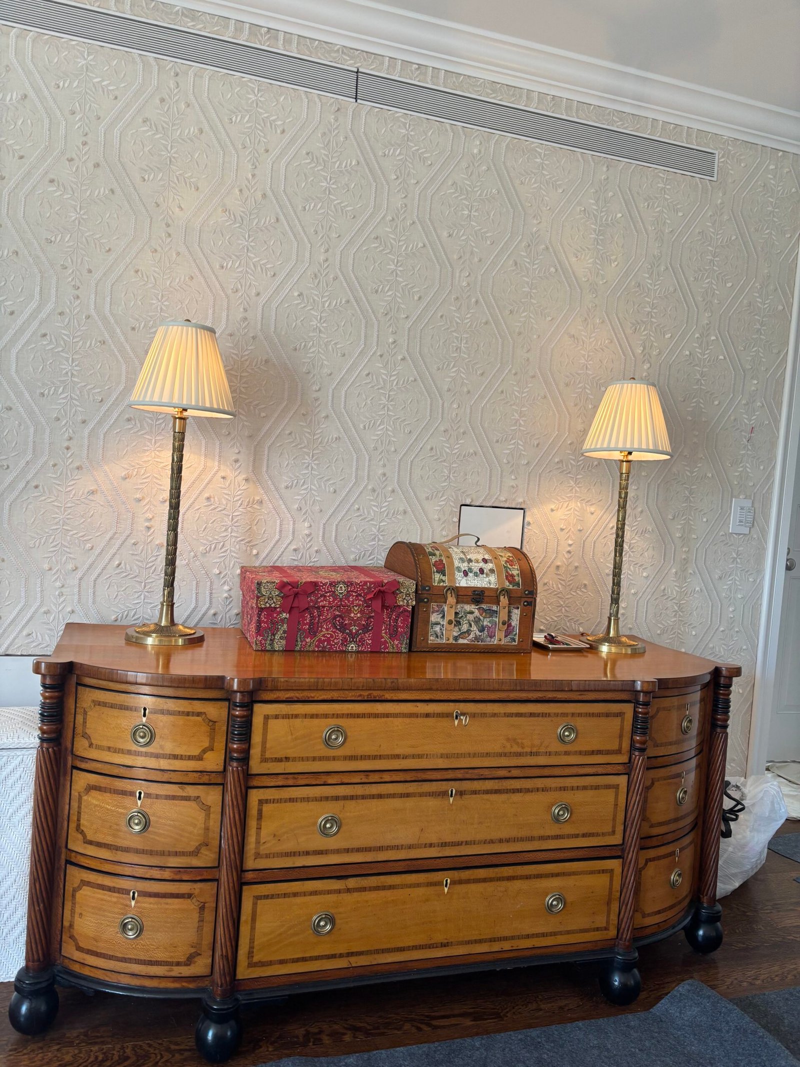 Antique chest with table lamps placed against a wall, NYC