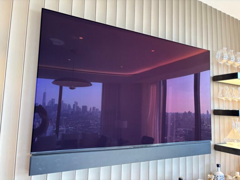 TV and soundbar mounted on a fluted wall with skyline view, NYC