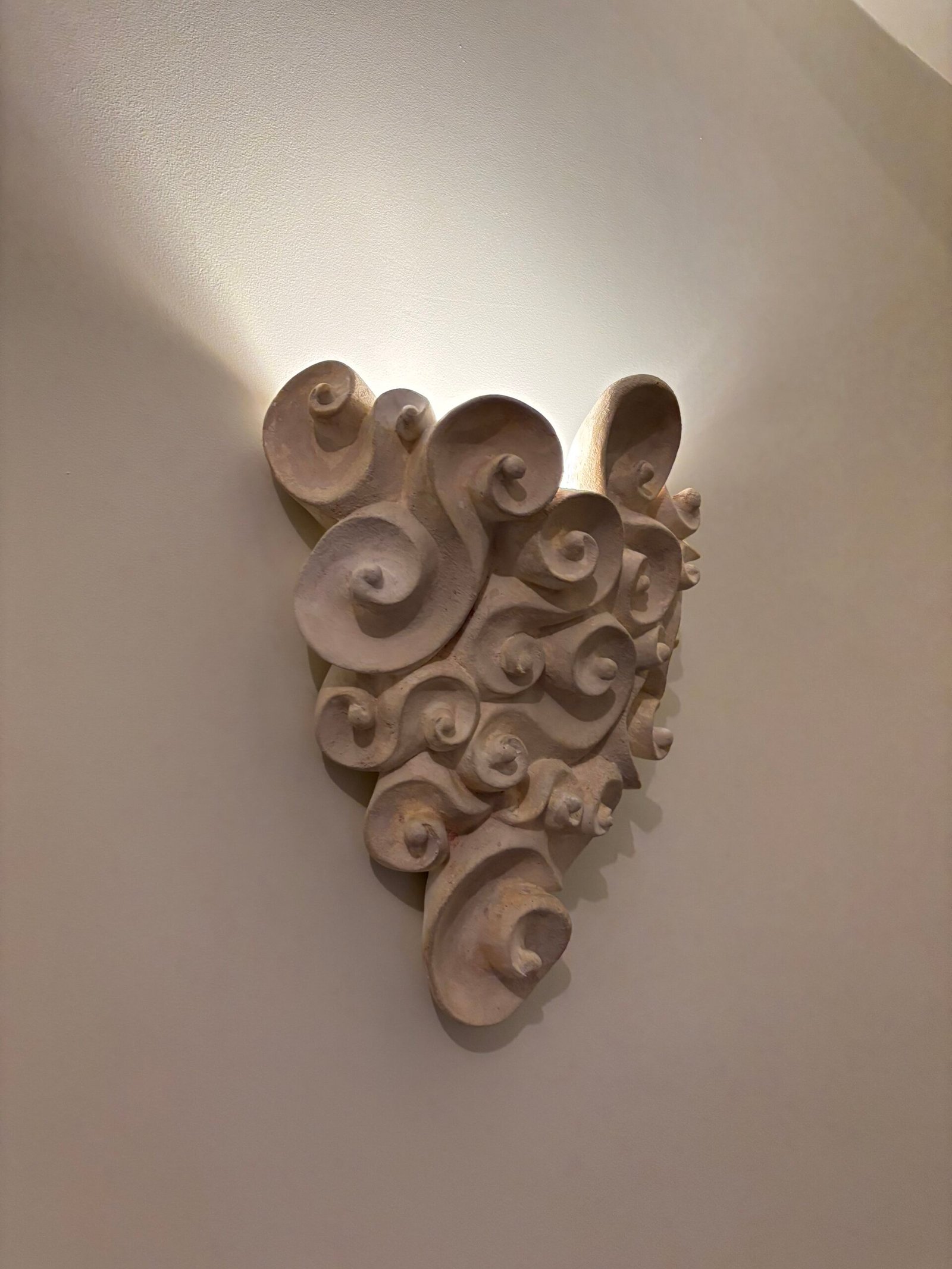 Carved decorative wall sculpture mounted on a wall, NYC