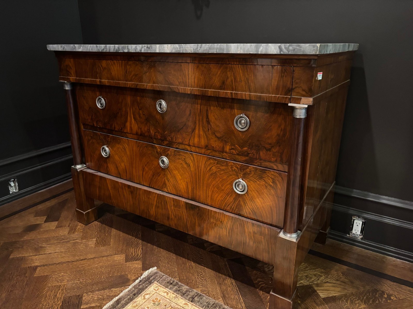 Antique wood chest of drawers with marble top placed, NYC
