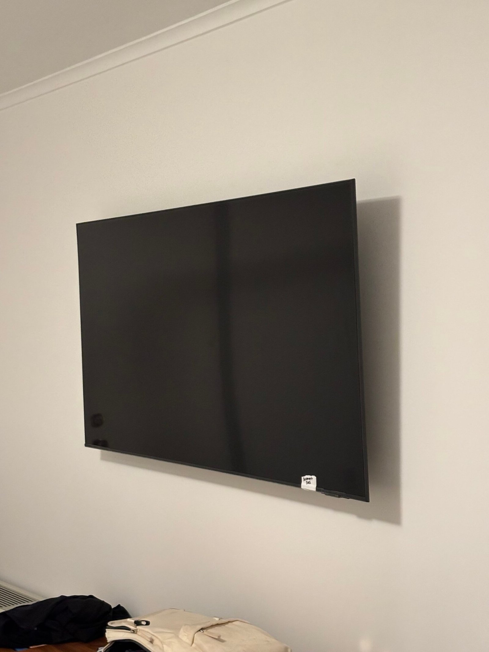 Flat screen TV mounted on a wall at an angle view, NYC