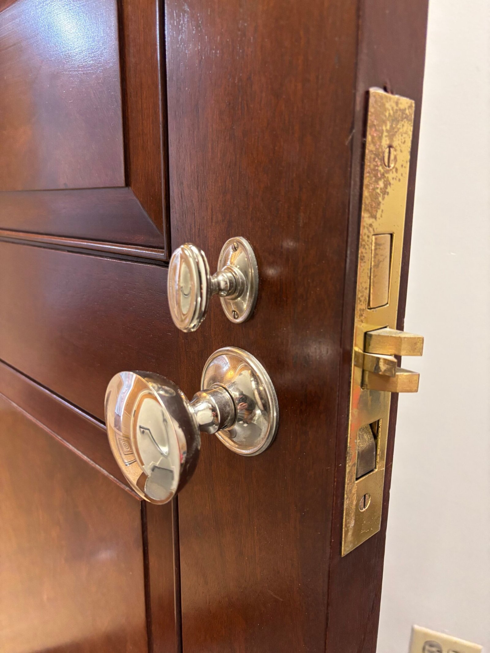 Door knob and deadbolt installed on a wood door, NYC