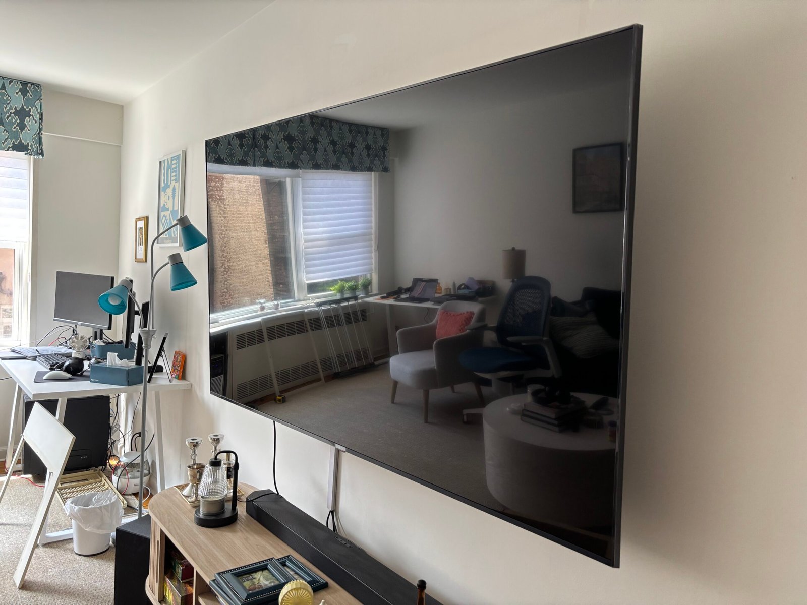 Large TV mounted on a wall in a living room with soundbar, NYC
